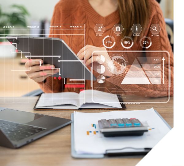 Woman analyzing digital data on a tablet with financial charts and calculator on desk – Neutrinos.